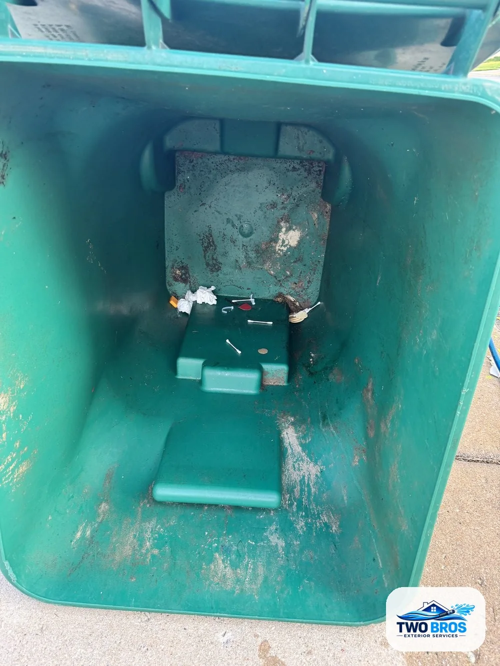 Garbage can interior before cleaning, showing dark grime and residue
