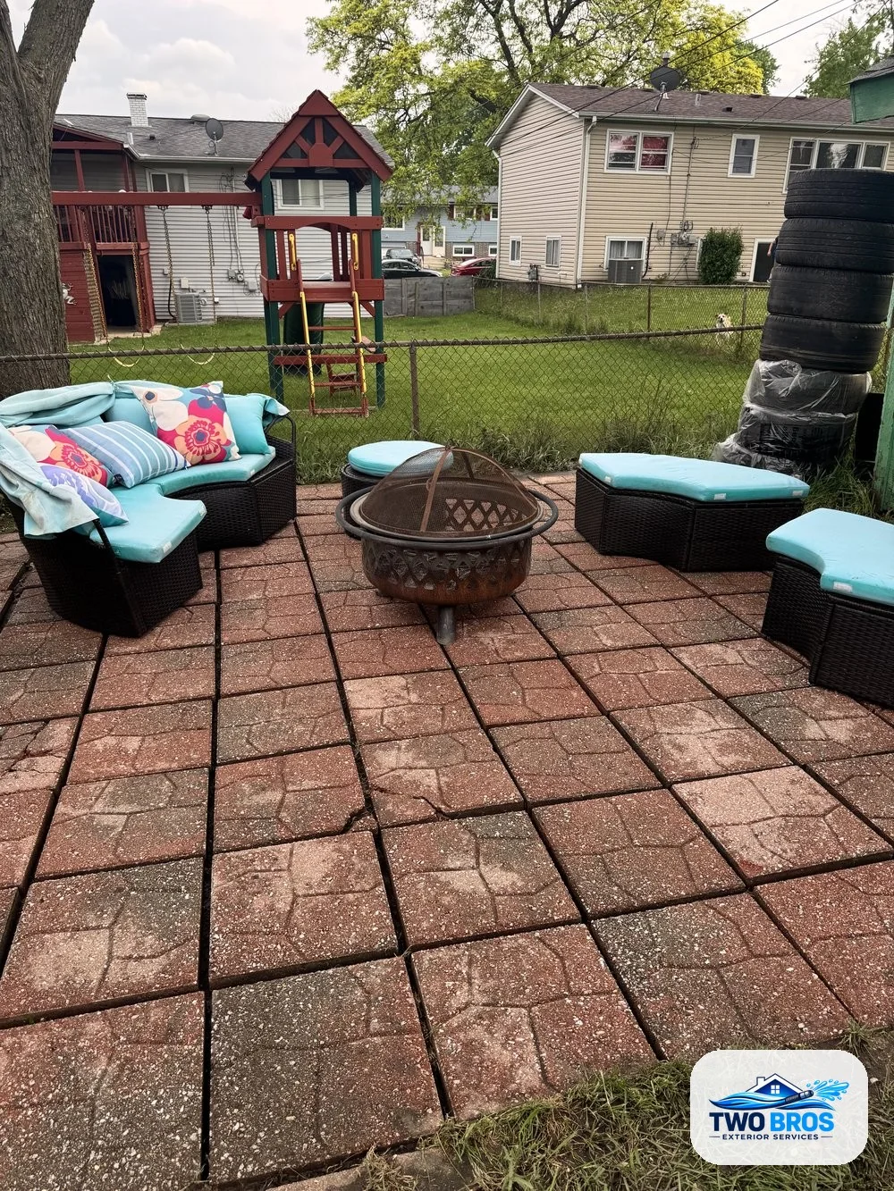 Paver patio after pressure washing, cleaned with furniture placed back in place